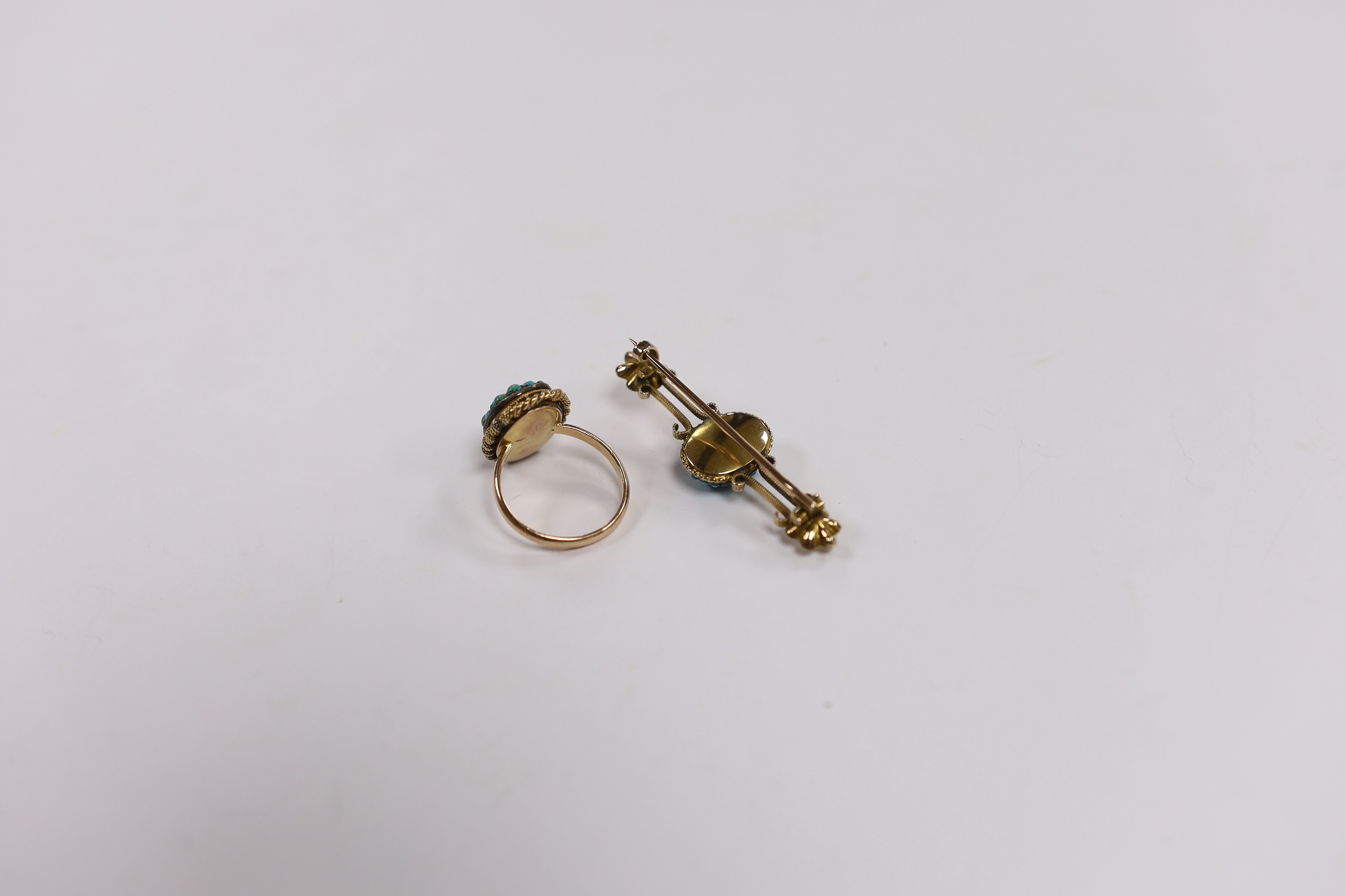 A Victorian 9ct and oval turquoise cluster set dress ring, size P and a similar yellow metal and turquoise set bar brooch, gross weight 9.7 grams.